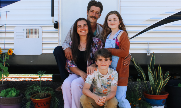 Perry family sitting in front of an RV