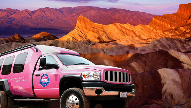Picture of pink truck in front of scenic Grand Canyon. 