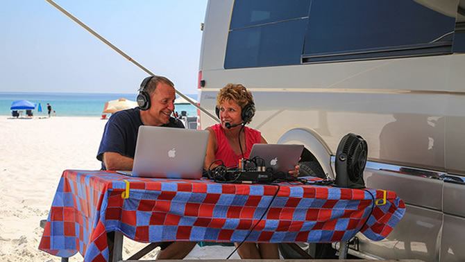 Mike and Jennifer prepare their podcast from the beach