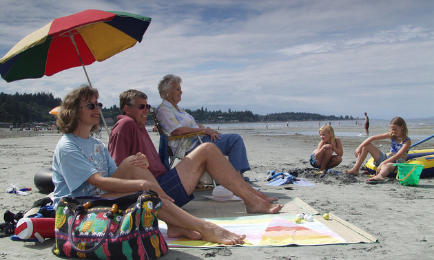 families lounging on the beach