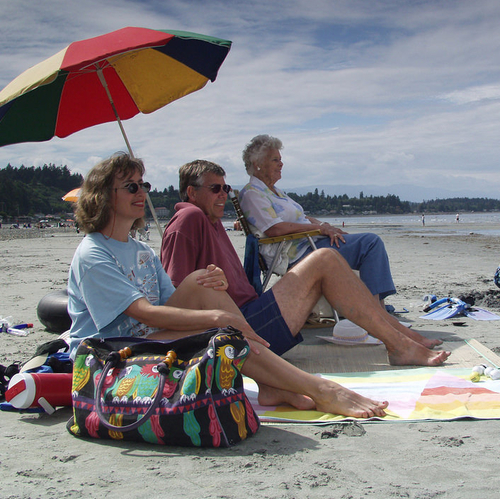 families lounging on the beach