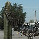 metal sculpture of a whale at the side of the road