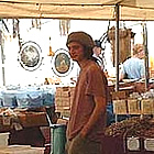 man standing behind a counter selling crafts at the Quartzsite show