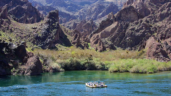 Picture of group of people rafting down river. 