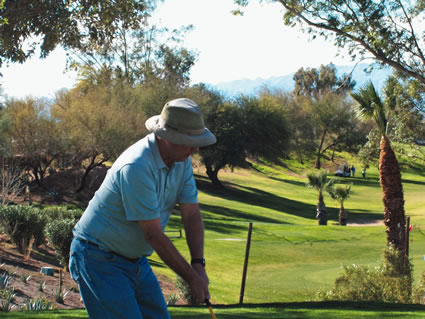 a golfer prepares to take a swing on a golf course