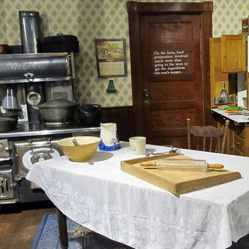 A kitchen with a vintage table and stove set with various utensils is one exhibit at the Western Development Museum in North Battleford.