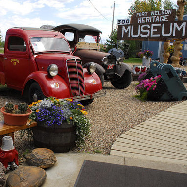 Antique cars and trucks are parked at the Fort Nelson Heritage Museum, which offers visitors a chance to learn about the building of the Alaska highway.