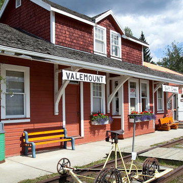 The front of the Valemount Museum is covered in red boards and has a bench on the front porch. It used to be the town's first train station.