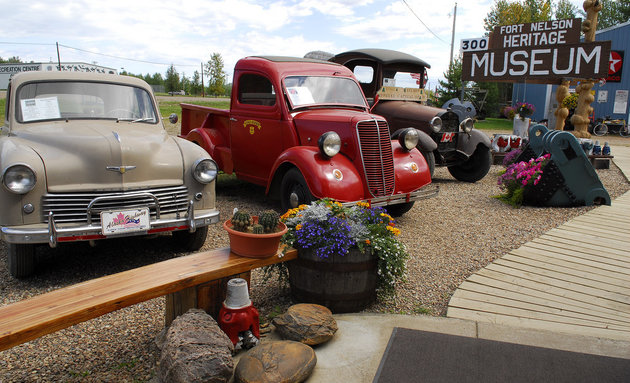 Antique cars and trucks are parked at the Fort Nelson Heritage Museum, which offers visitors a chance to learn about the building of the Alaska highway.