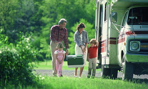 people gathered by their RV camping