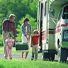 people gathered by their RV camping