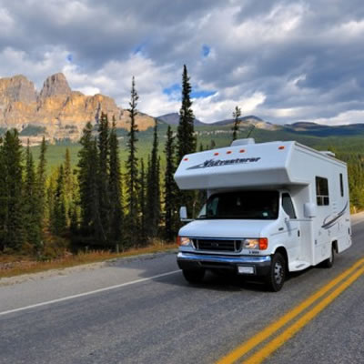 Picture of fifth wheel travelling down highway. 