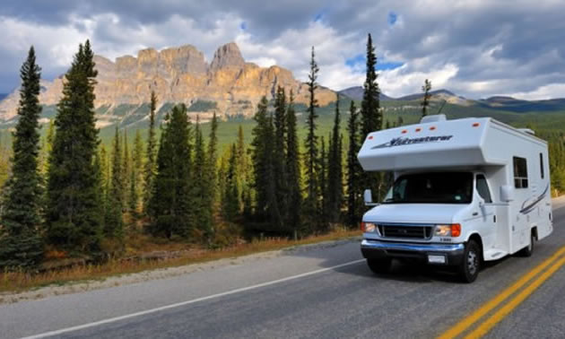 Picture of fifth wheel travelling down highway. 