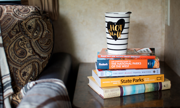 Colorful books and a fun coffee mug brighten up this space and avoid taking up cabinet storage.