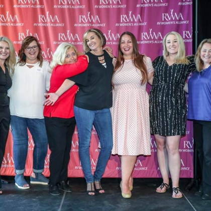 RVWA members standing against a background with their logo on it