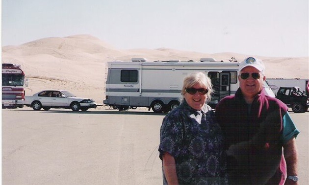 Carol and Don McDowall standing in front of their RV.