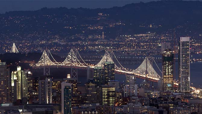 Picture of San Francisco-Oakland Bay Bridge lit up at night. 