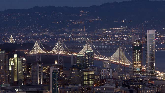 Picture of San Francisco-Oakland Bay Bridge lit up at night.
