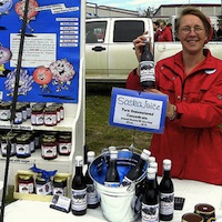 Barb Geisbrecht at the Fort St. John farmers market.  She is selling saskatoon jams, sauces, juice concentrate, candles, pie filling and pies.