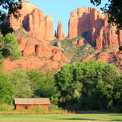 Picture of cabin with sandstone mountains in background. 