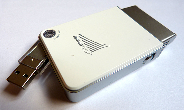 A white and silver shaver with a USB on it.