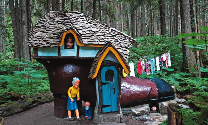 wooden house and figurines in forest