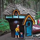 wooden house and figurines in forest