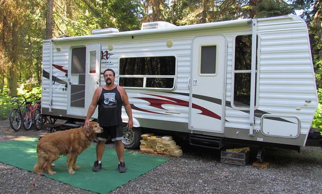 Greg Mykytiuk and his dog Bear enjoying the quiet campsite at Mount Fernie Provincial Park.