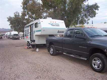 A black truck pulls an RV