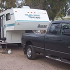 A black truck pulls an RV