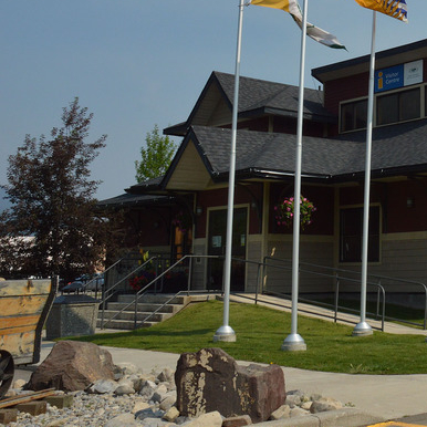 Shown is the front entrance of the Sparwood Chamber of Commerce with the Titan truck beside it.