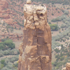 Two narrow rocks tower over a desert landscape