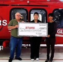 Nafisa Taimuri (right), of the STARS Foundation accepts a cheque for $2148 from Duane and Lynda Pilson hosts of the RVwest Rally.  