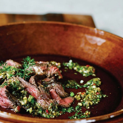 Five-spice steak in a plate with sauce on top. 