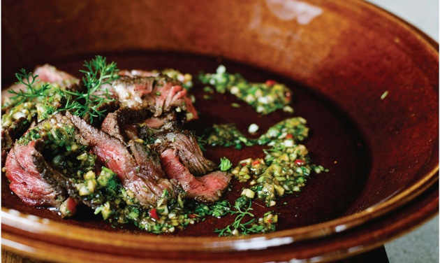 Five-spice steak in a plate with sauce on top.