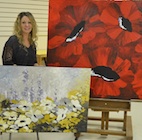 Camrose artist Tara Szott with her enormous floral canvases.