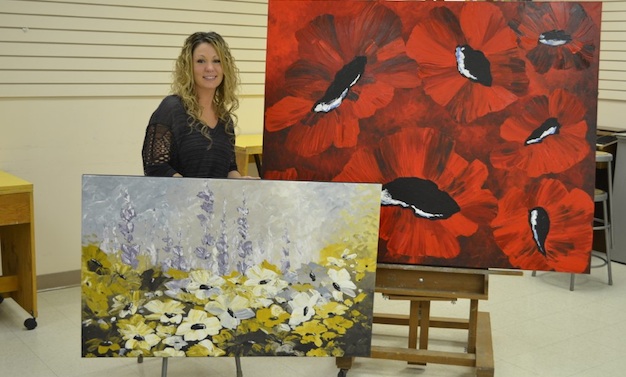 Camrose artist Tara Szott with her enormous floral canvases.