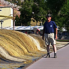 man standing next to a hot spring