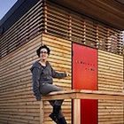 Isabella Mori on the porch of her tiny house, which she called Thousand Crows.