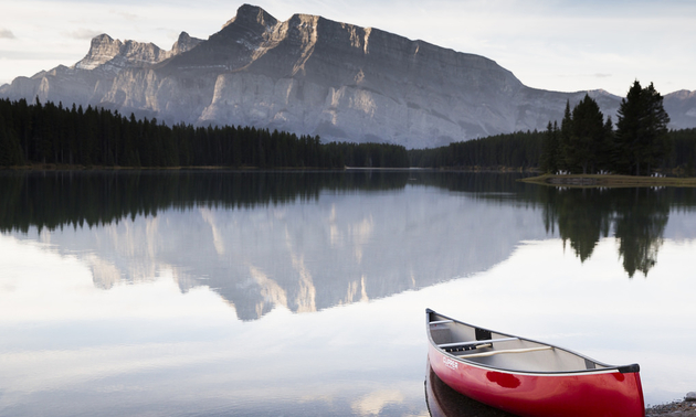 Canoe resting on a bank near mountains