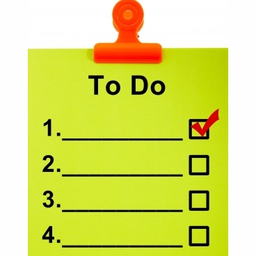 A To Do list in lime green, held up by a red clip. 