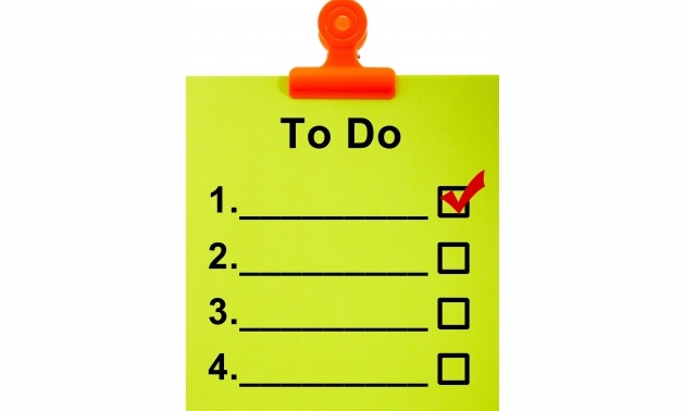 A To Do list in lime green, held up by a red clip. 