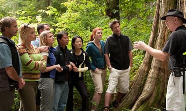 A man guiding a tourist group. 