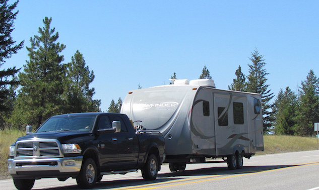 A truck and RV travelling down the highway.