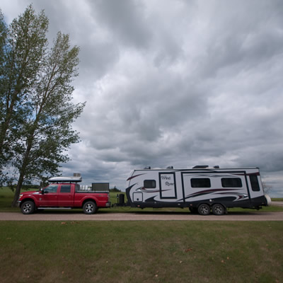 Truck hauling a fifth wheel trailer. 