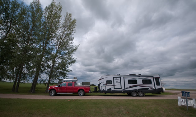 Truck hauling a fifth wheel trailer.
