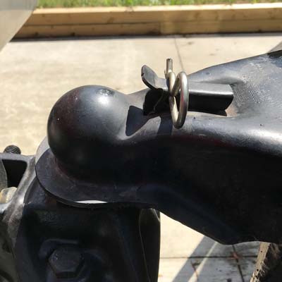 This pin locks the ball in the trailer socket, a critical step in preparing to tow.