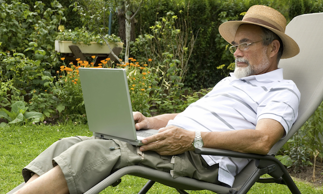 Man sitting in a lawn chair with a computer on his lap