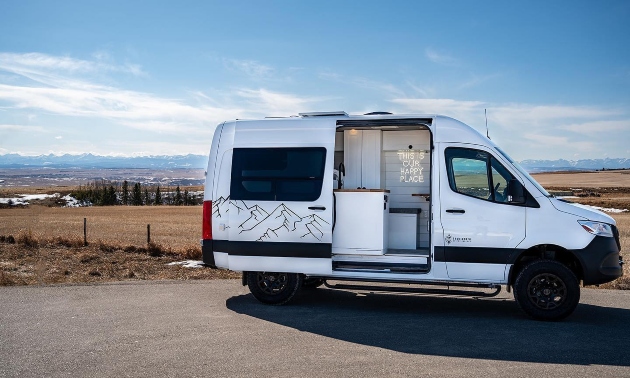 A campervan with the door open, on a sunny day