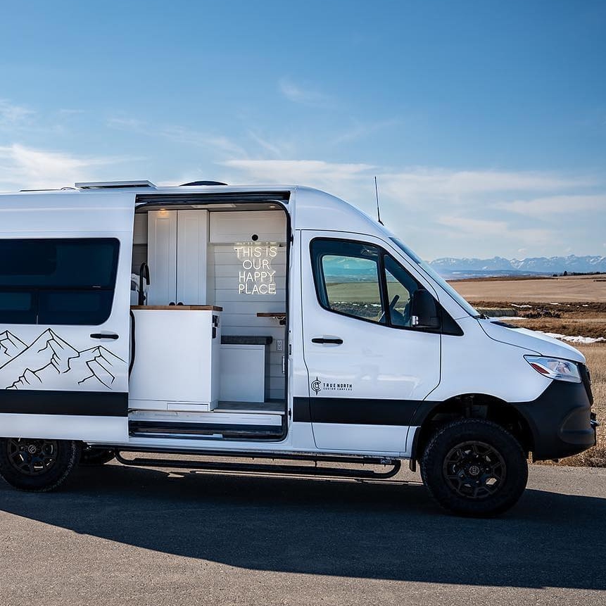 A campervan with the door open, on a sunny day